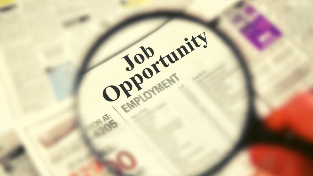 Companies Hiring Right Now - Image with magnifying glass over a newspaper with Job Opportunity text
